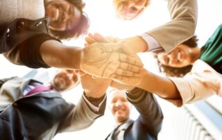 A diverse group of people with their hands together
